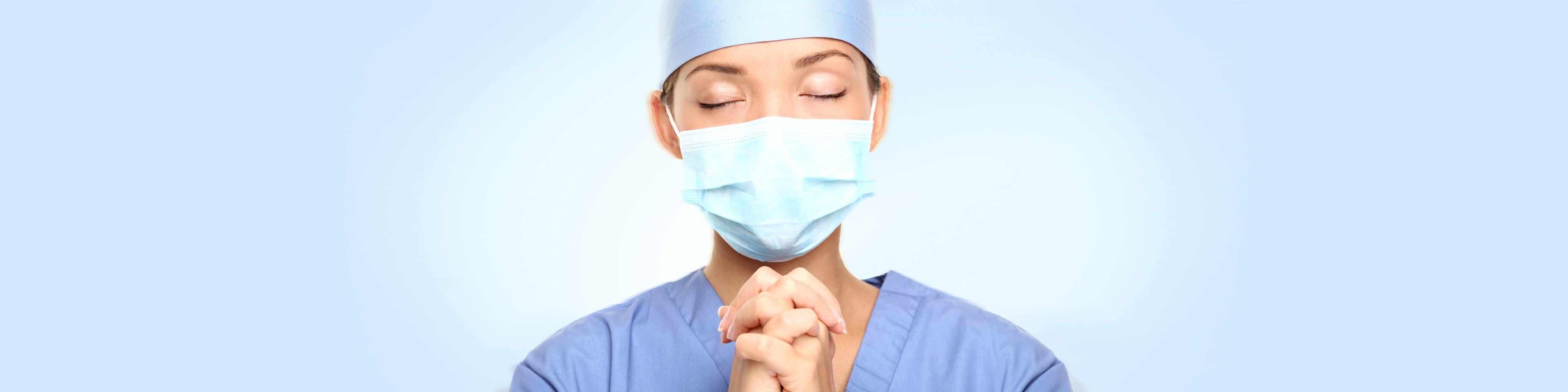 medical doctor with hands folded in prayer