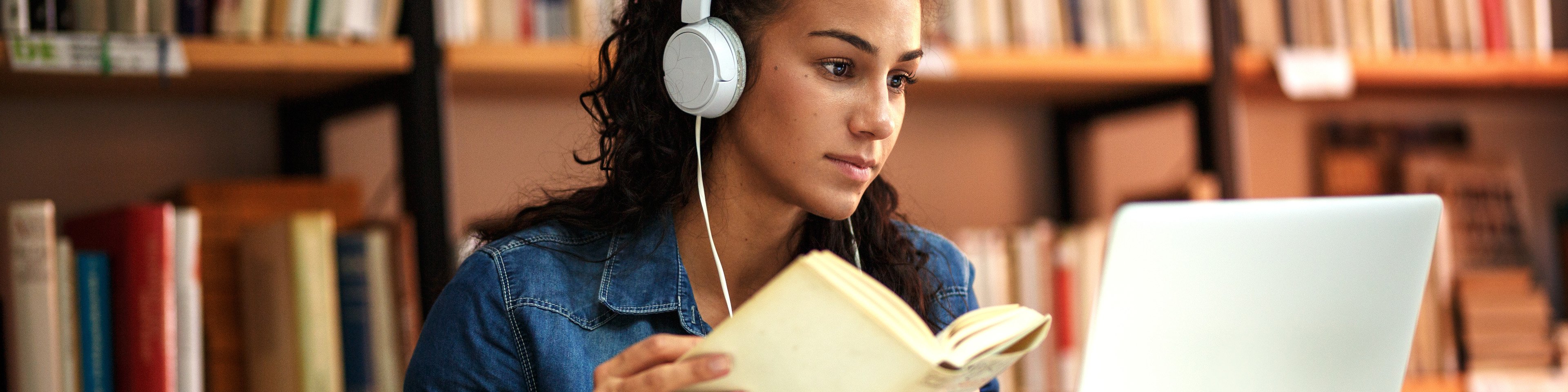 Young female student study in the school library using laptop