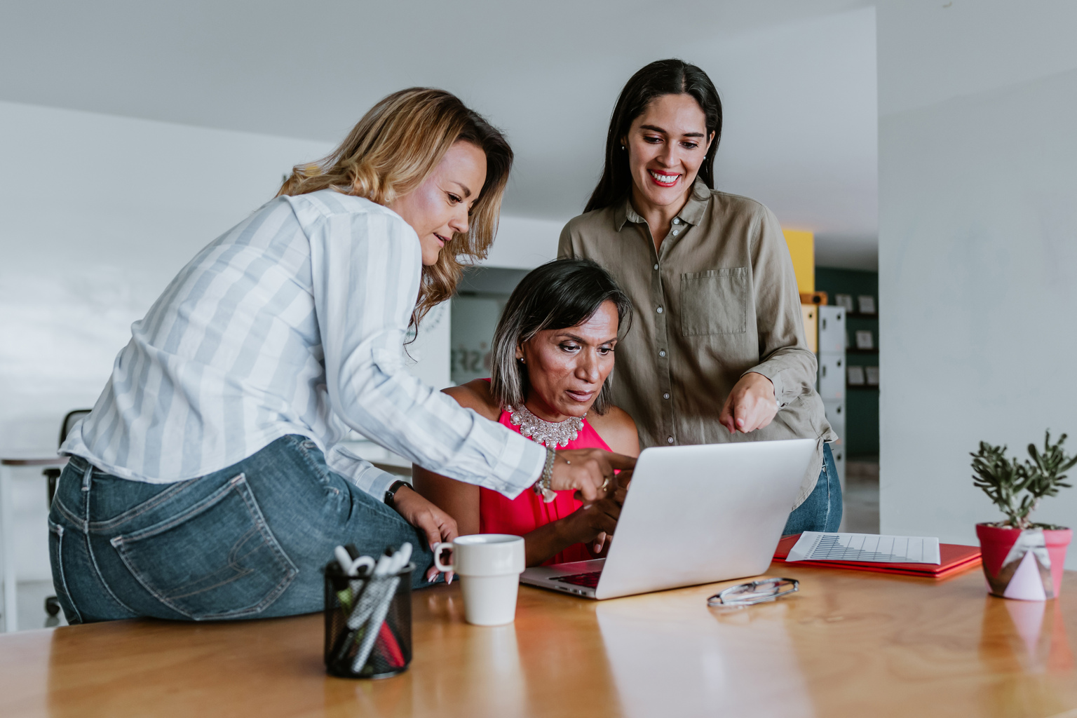 Transgender latin woman working with computer at the office