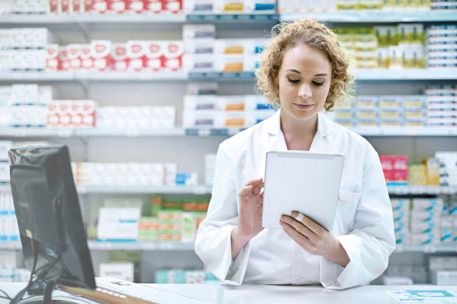 Farmaceutka sprawdza na tablecie prawo farmaceutyczne w LEX