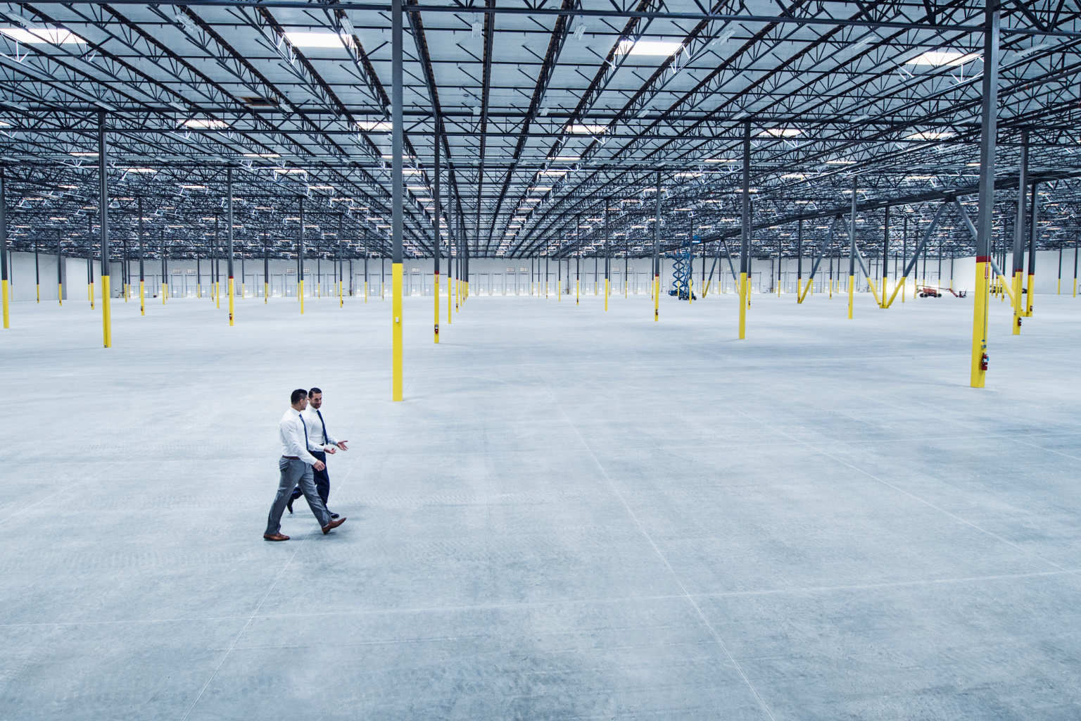 men walk through empty facility