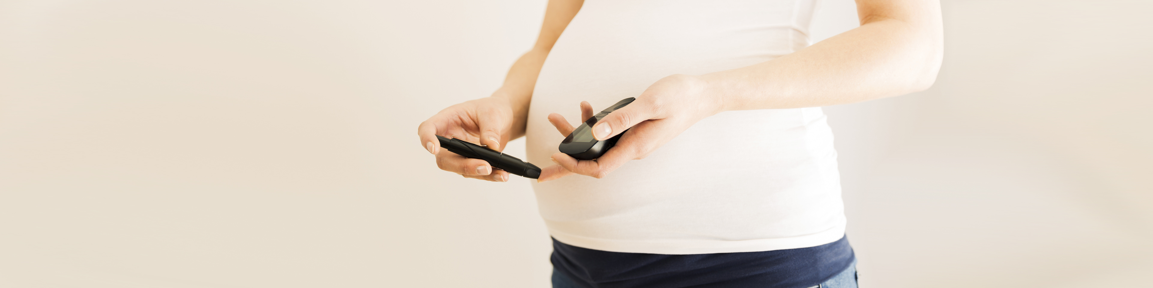 Pregnant woman with gestational diabetes checking blood sugar level