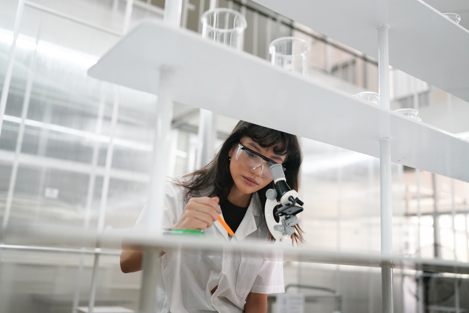 Medic working with a microscope at a laboratory.