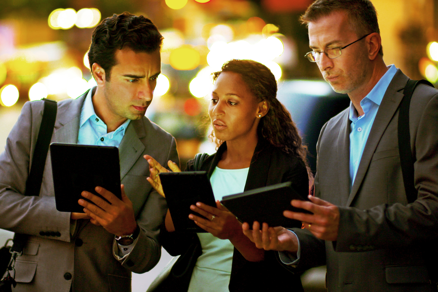 Businessmen & Businesswoman Using Digital Tablets