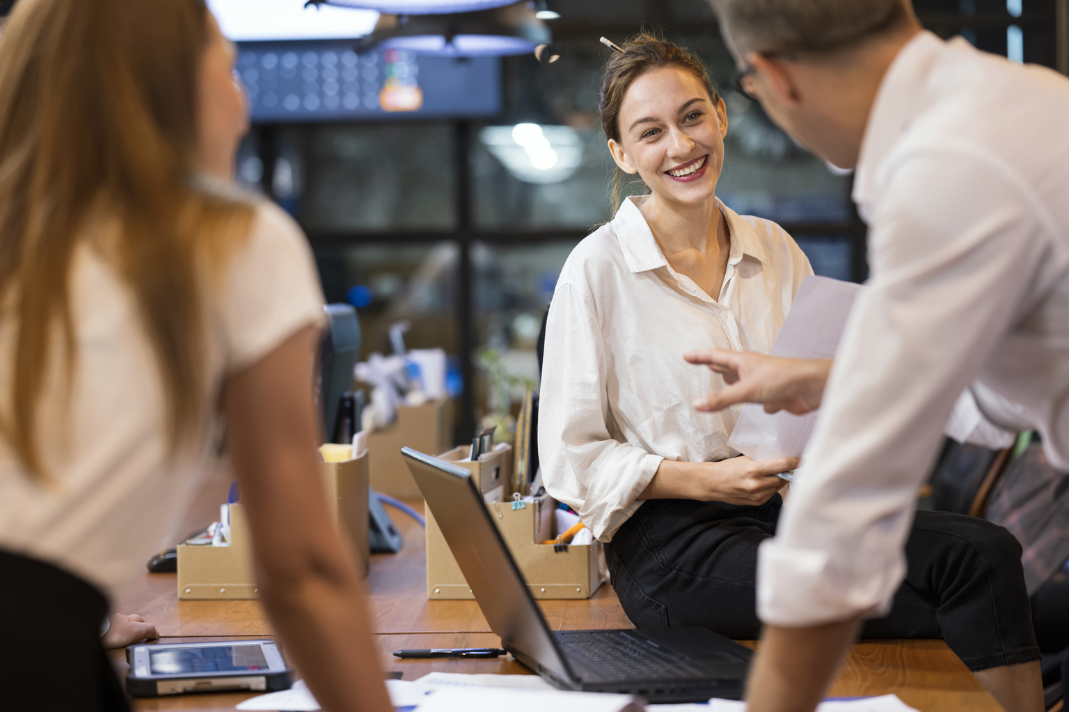 Smiling Female Software Developer leading a project meeting in tech business office