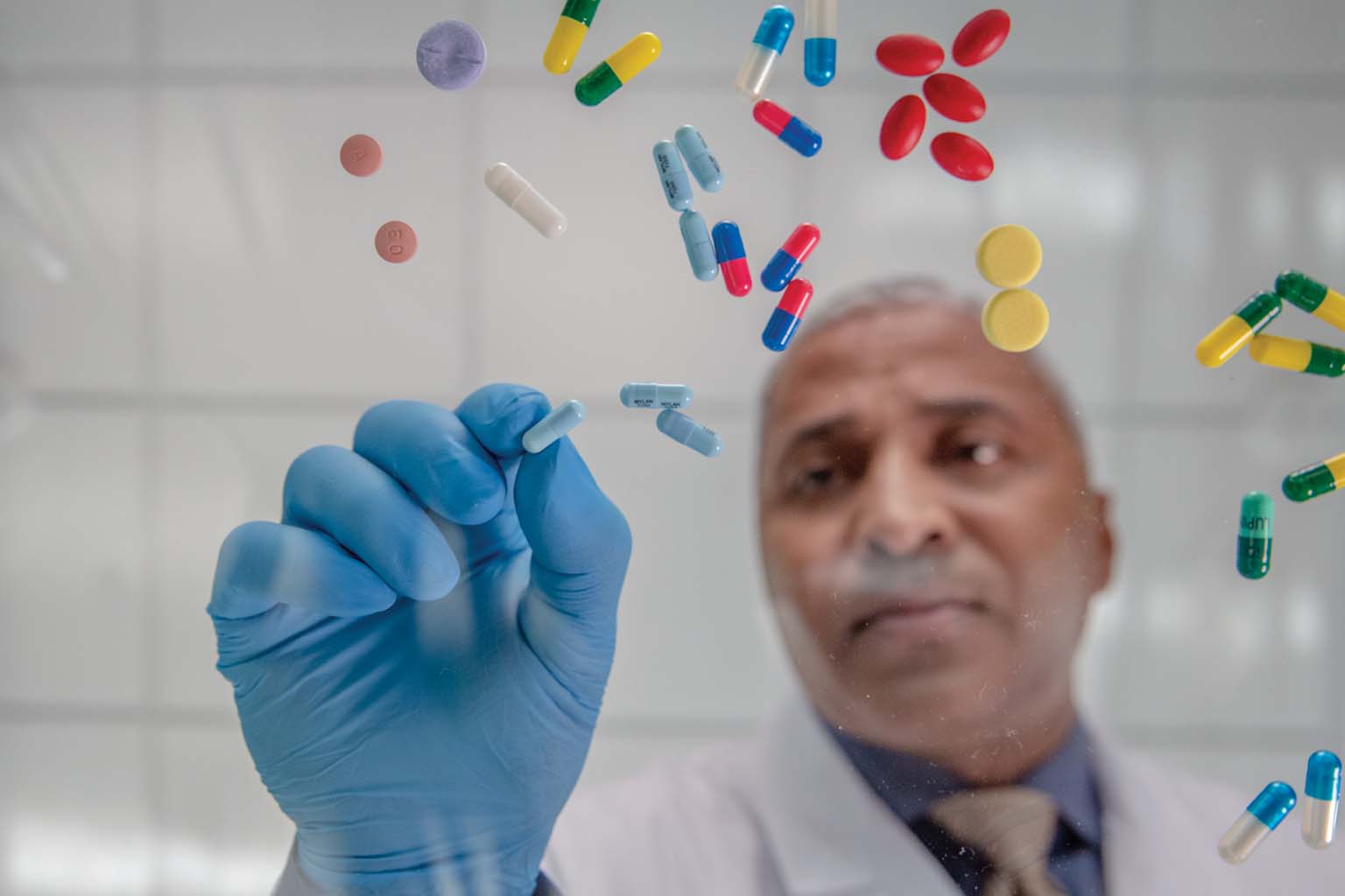 pharmacist sorting through a variety of pills
