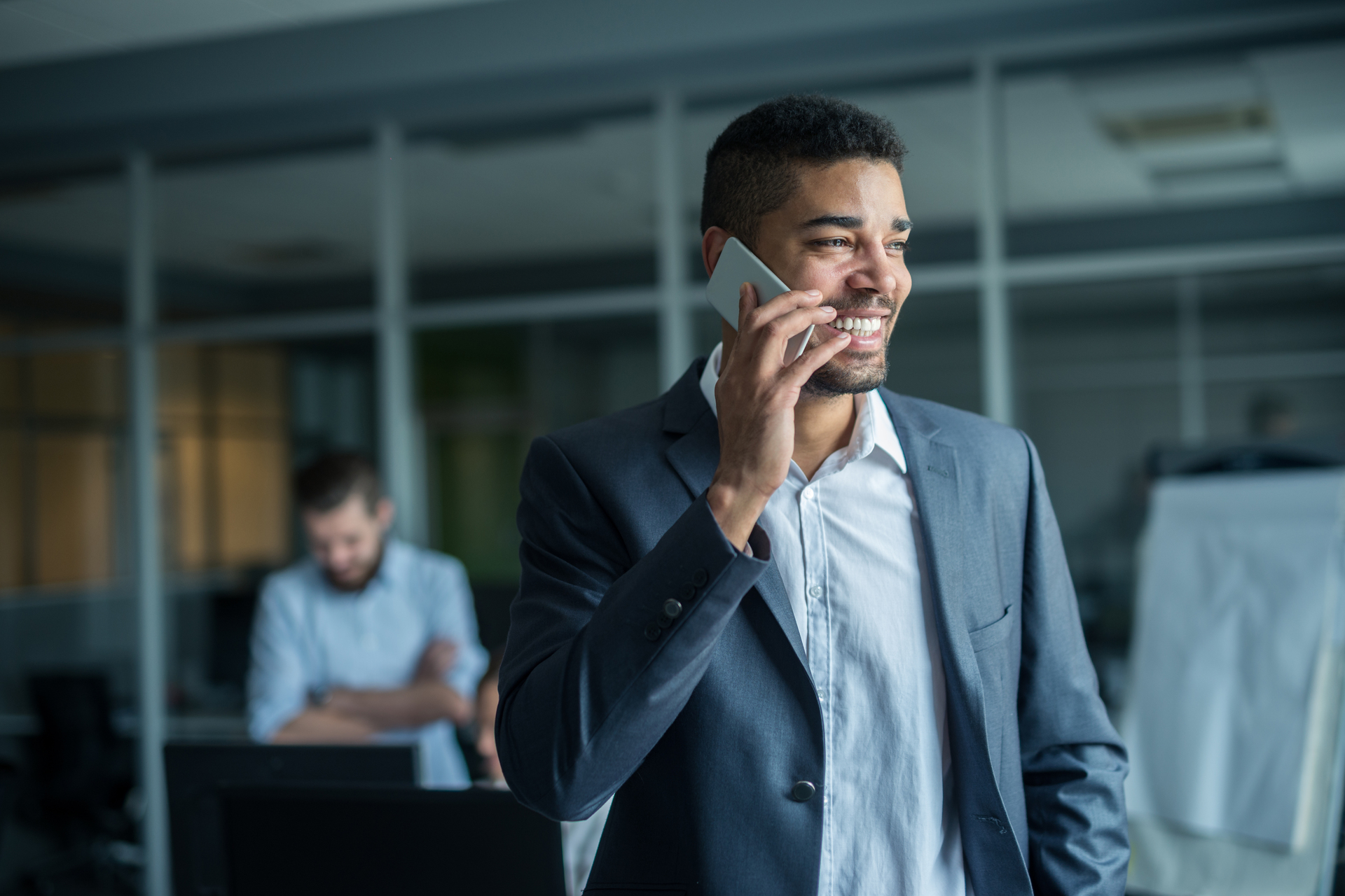 Handsome african american businessman texting on the phone.