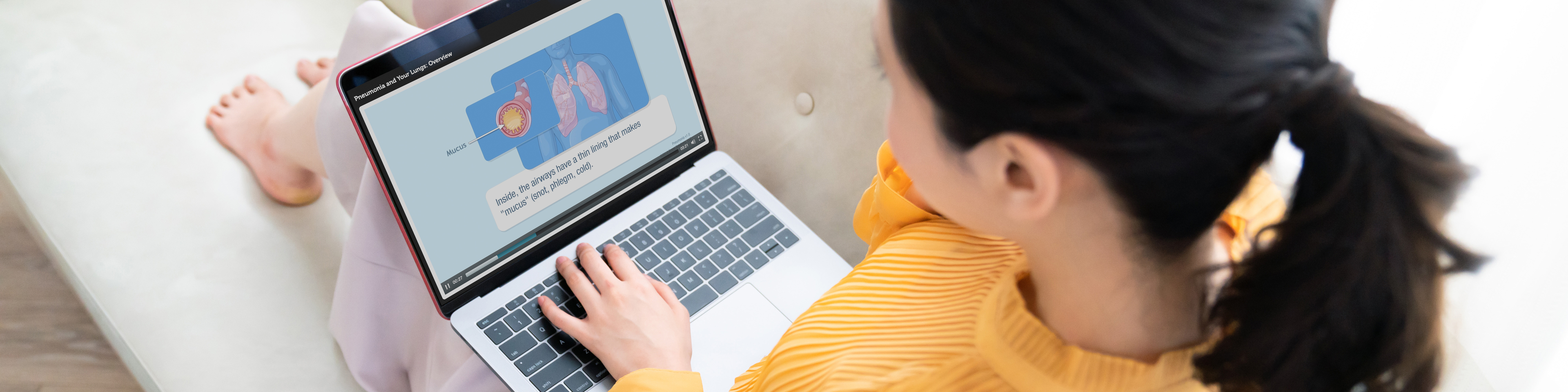 Young woman using a laptop in house, Emmi on the screen