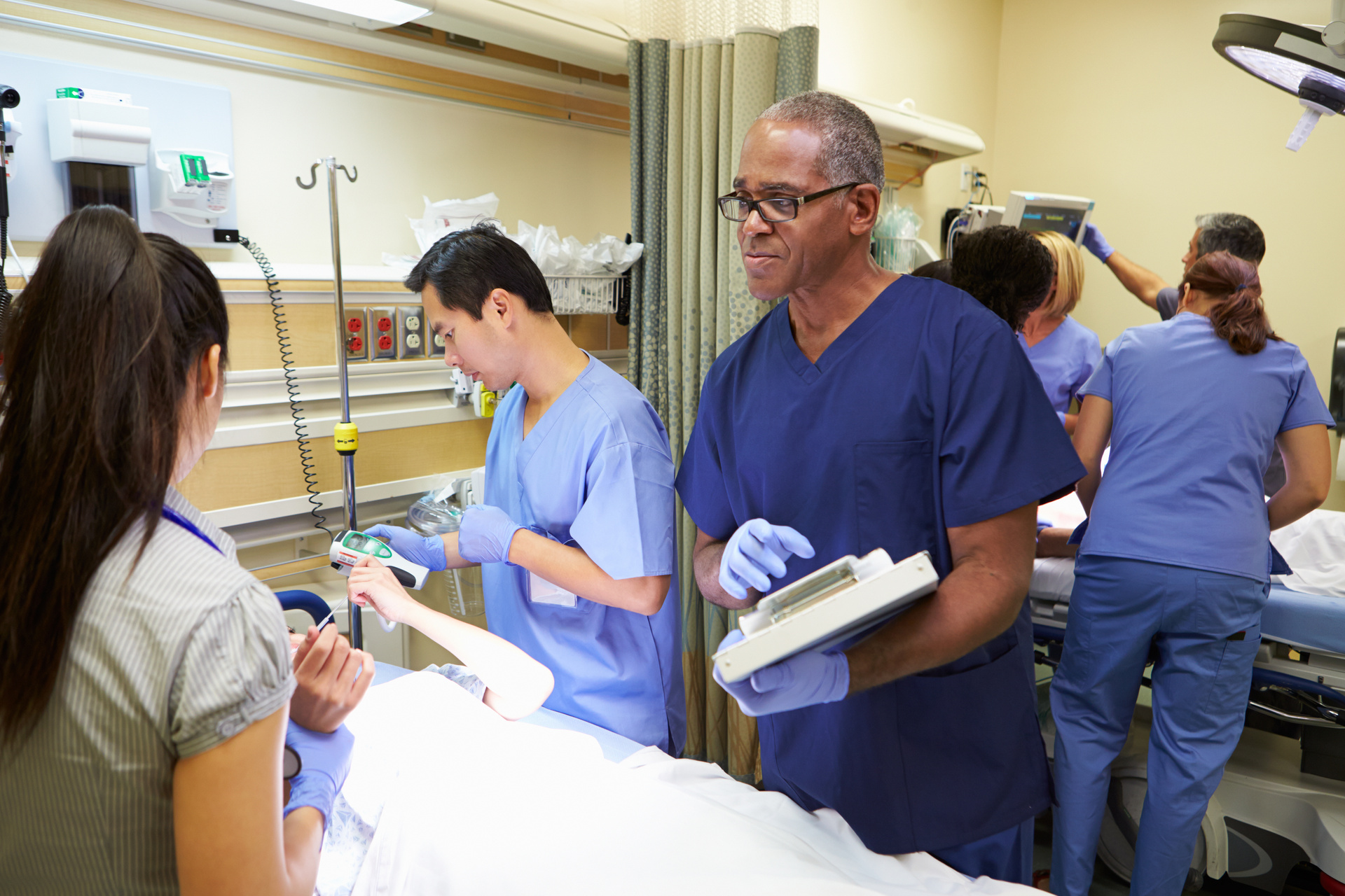 Medical team treating patient in emergency room