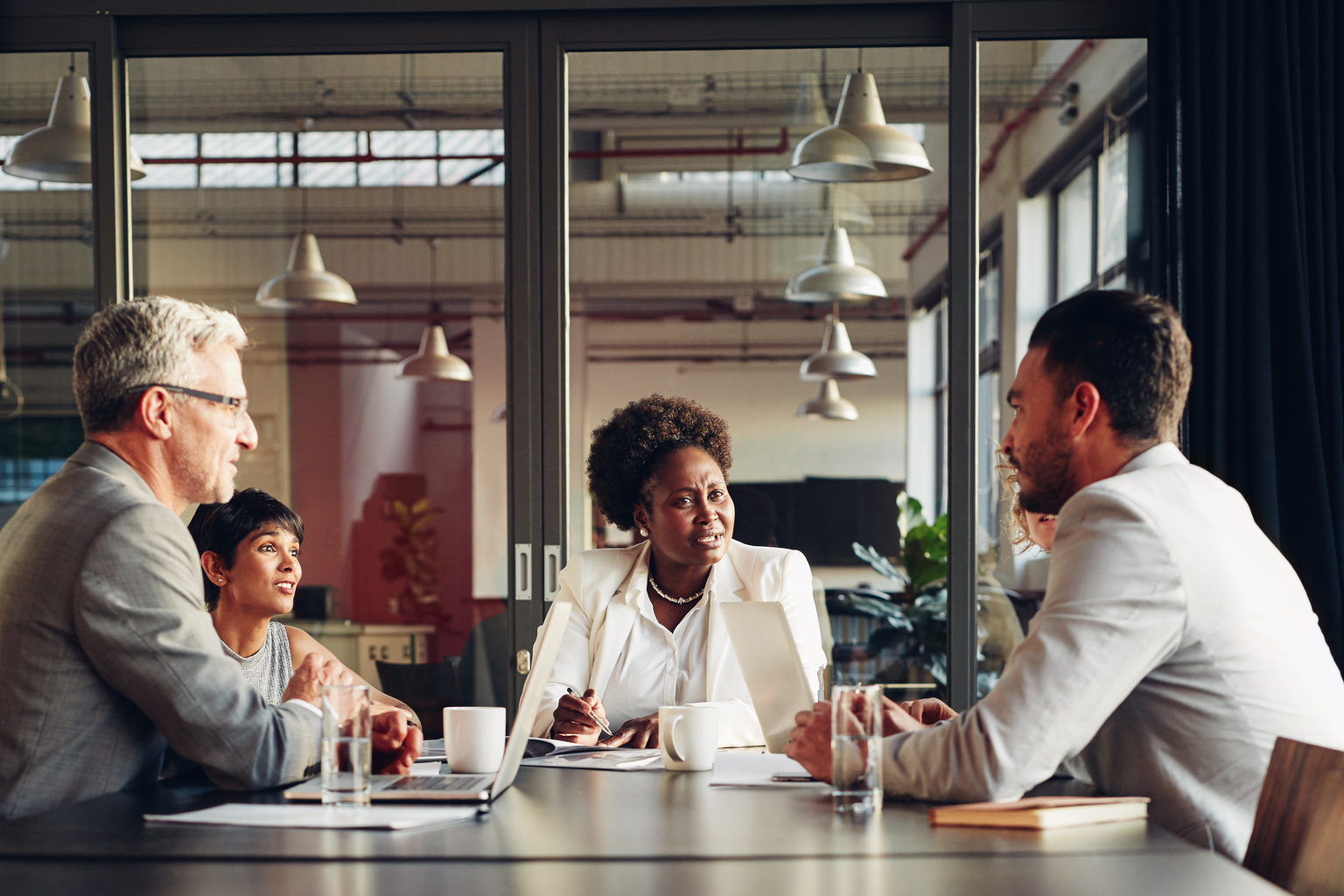 African American businesswoman listening to her team discussing work