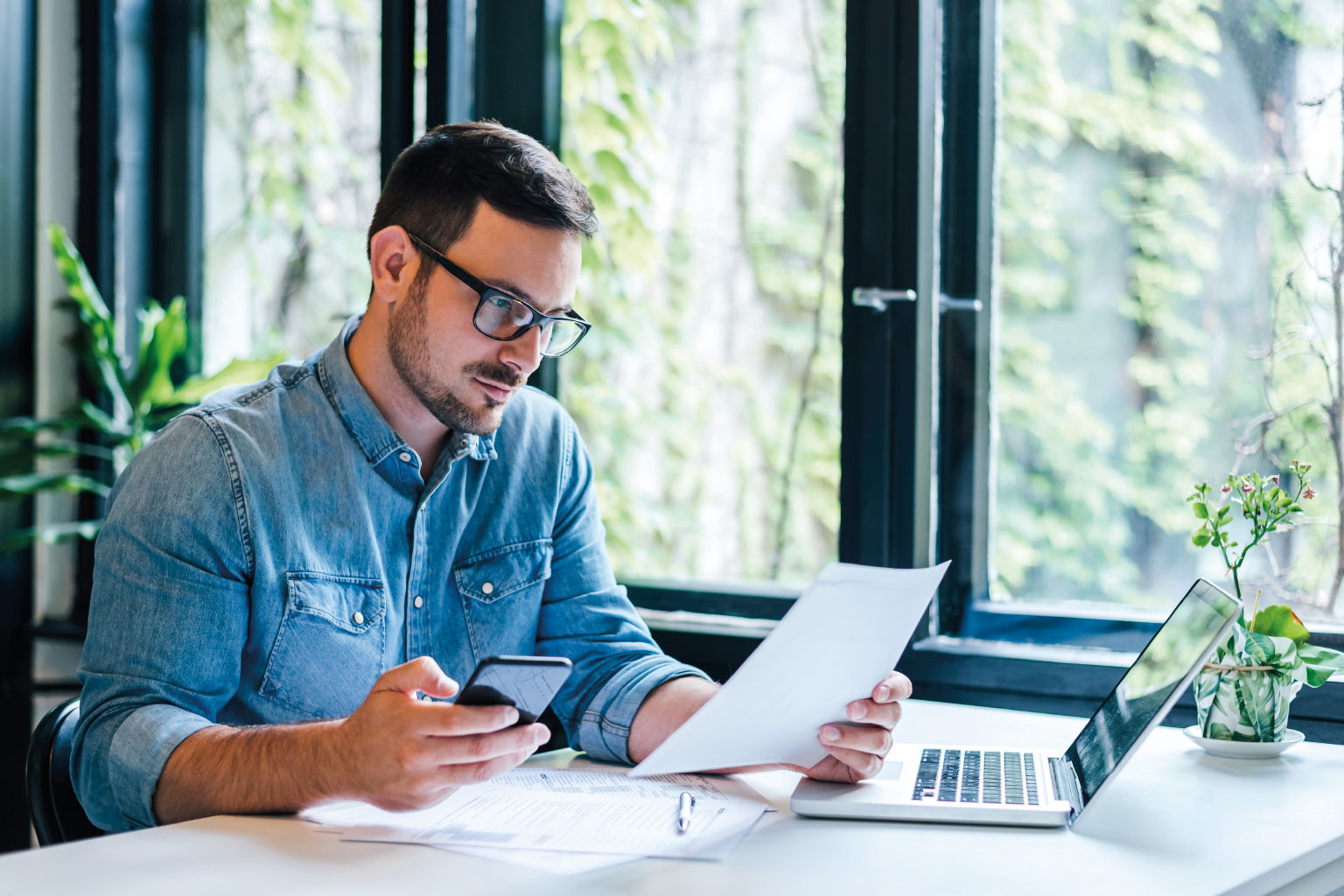 man with glasses looking at a document 2