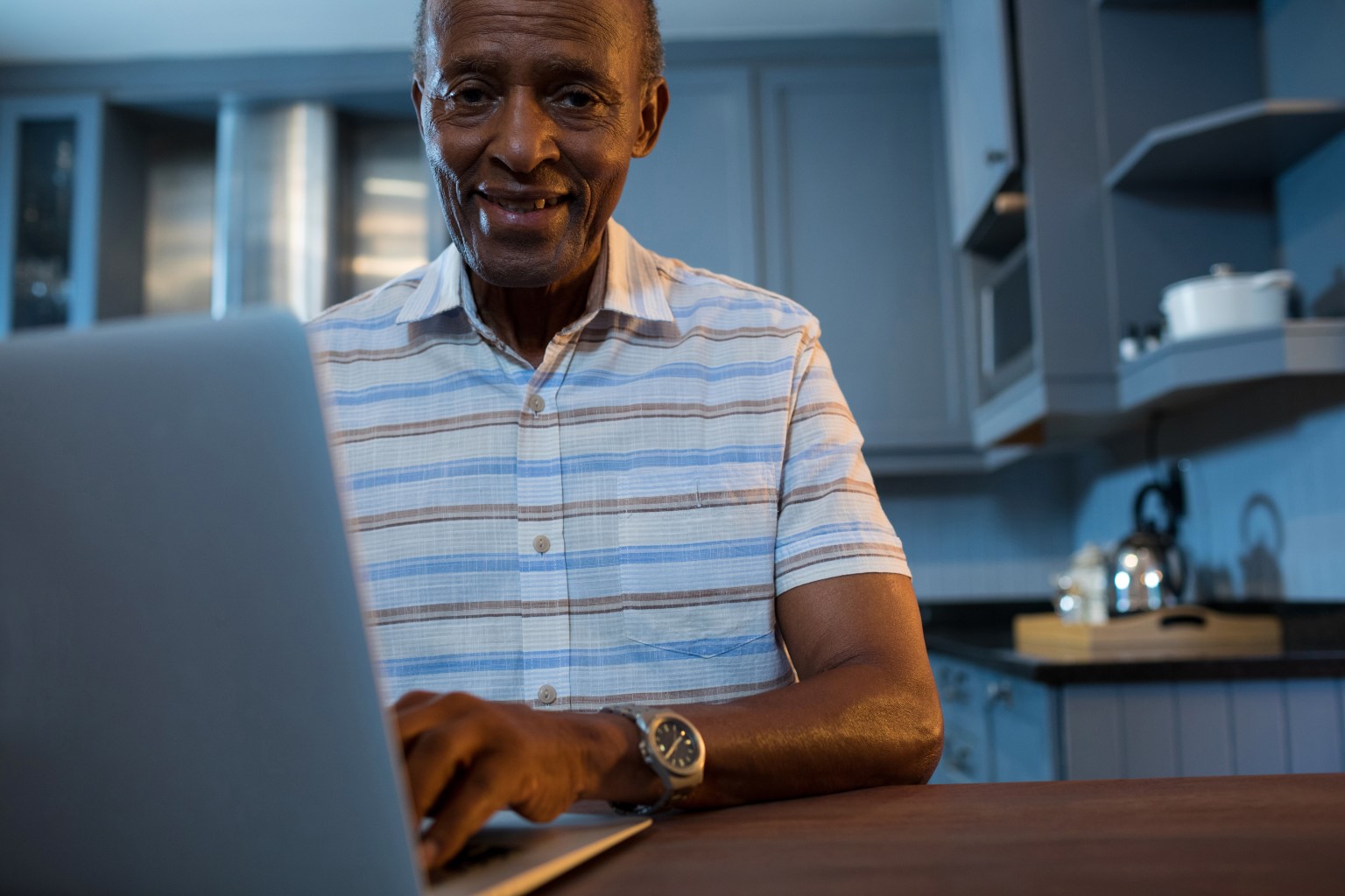 Elderly gentleman consulting a doctor via telehealth