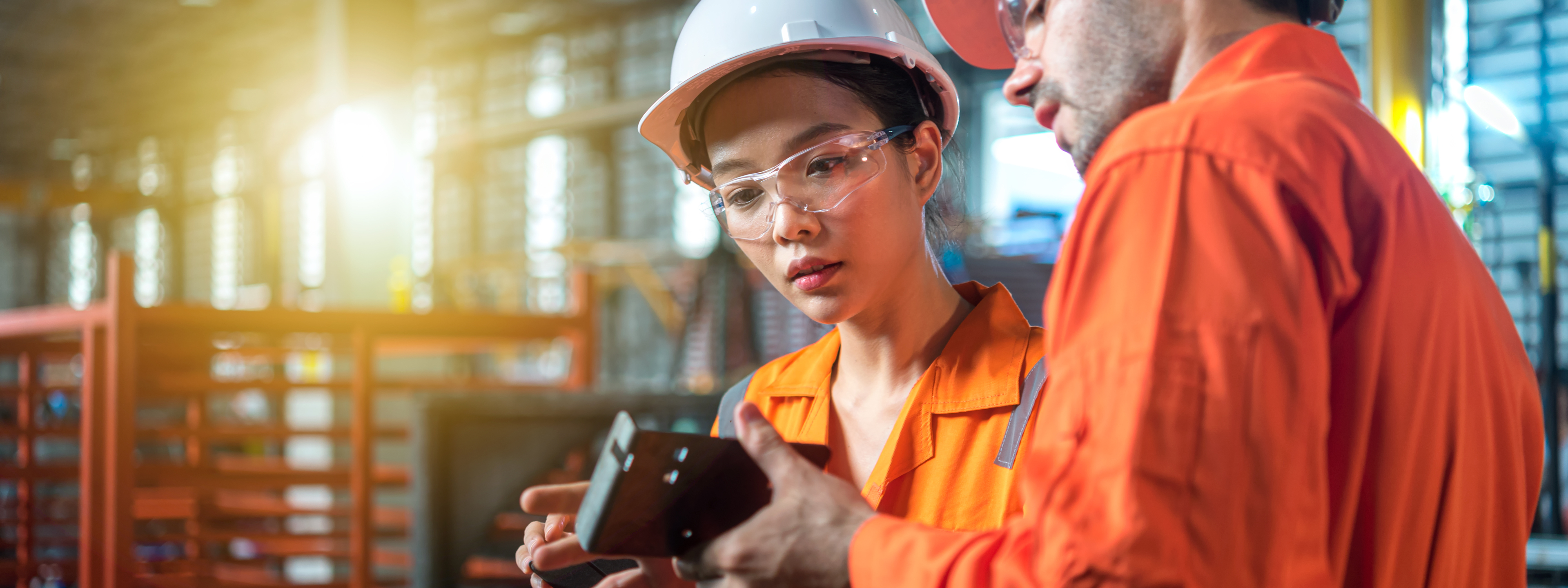 Male and female engineer are checking quality of product on hand