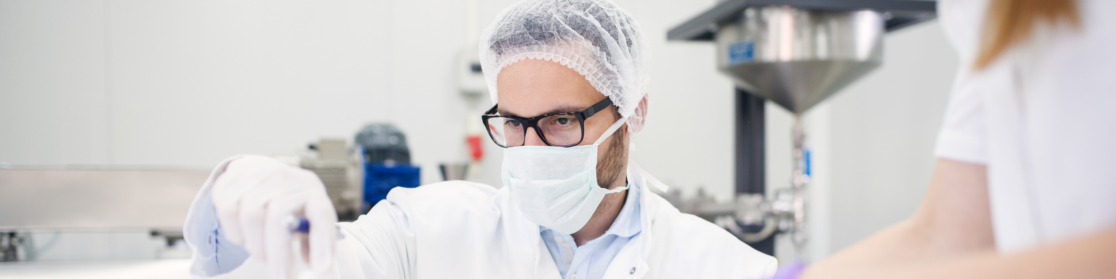 A scientist working in a licensed drug manufacturer's lab.