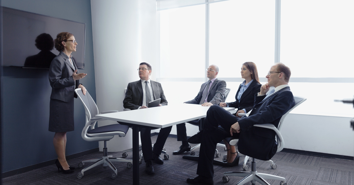 Businesswoman leading group meeting in office