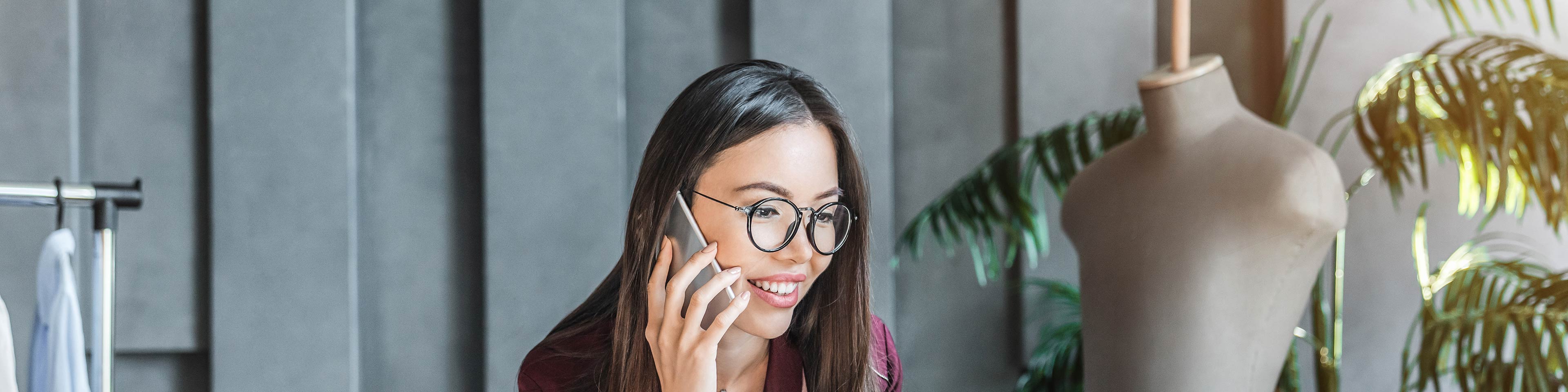 A businesswoman talking on the phone about needing an EIN