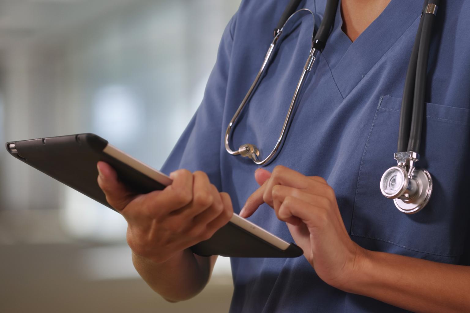 Female doctor or nurse with stethoscope and tablet