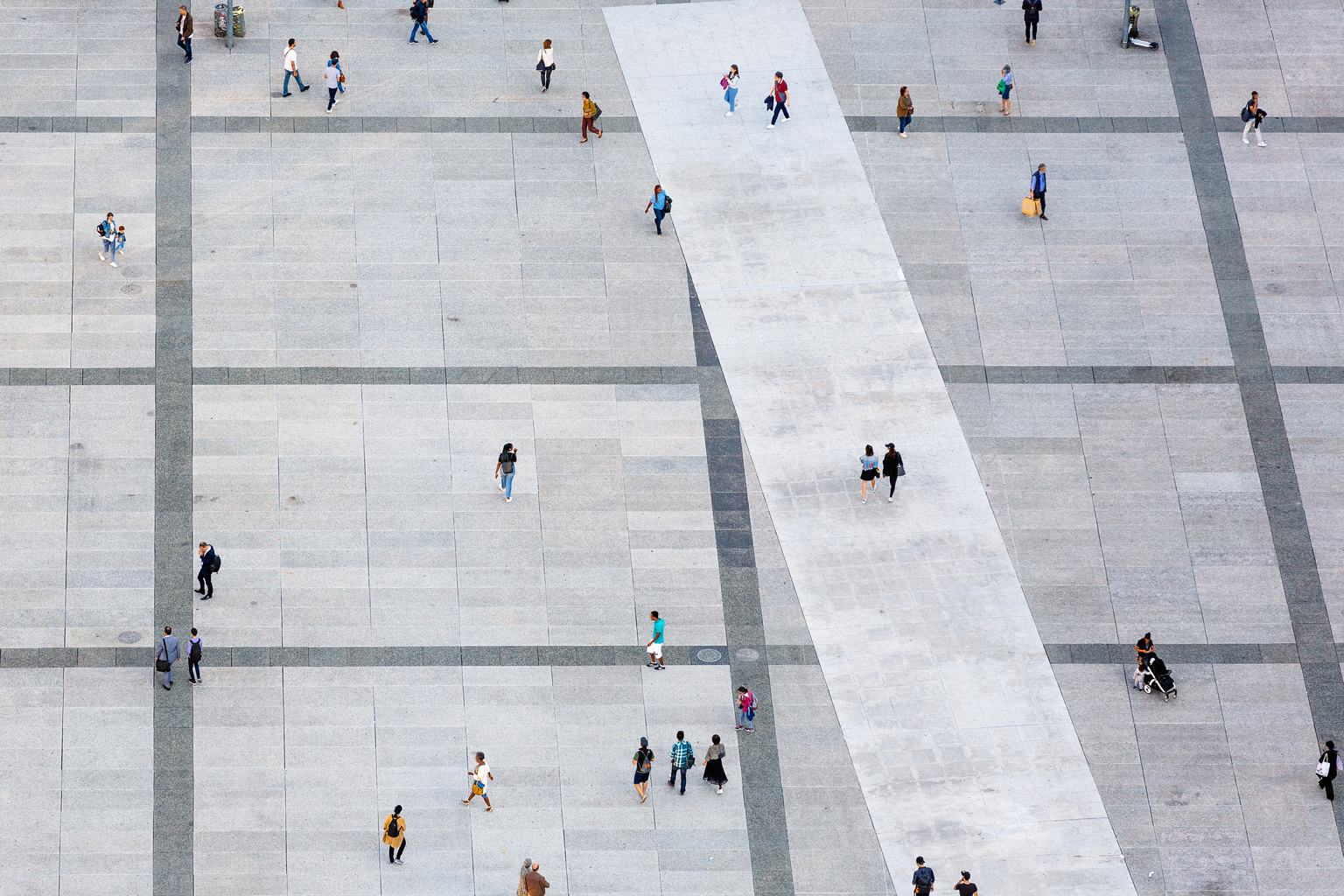 Aerial view of people walking at the city square,