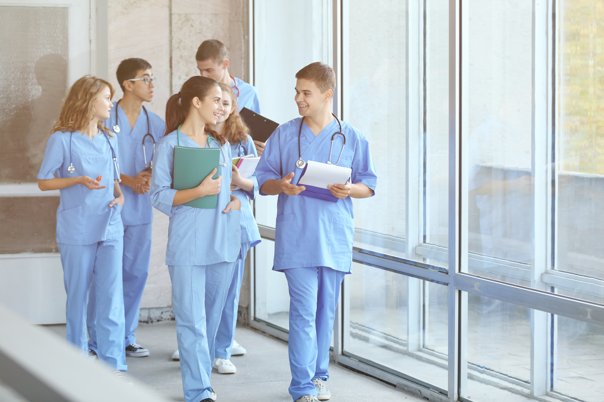 Group of medical professionals walking down hospital corridor