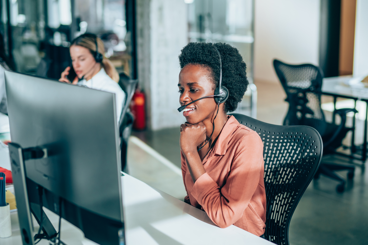 Smiling beautiful young african-american businesswoman working in call center