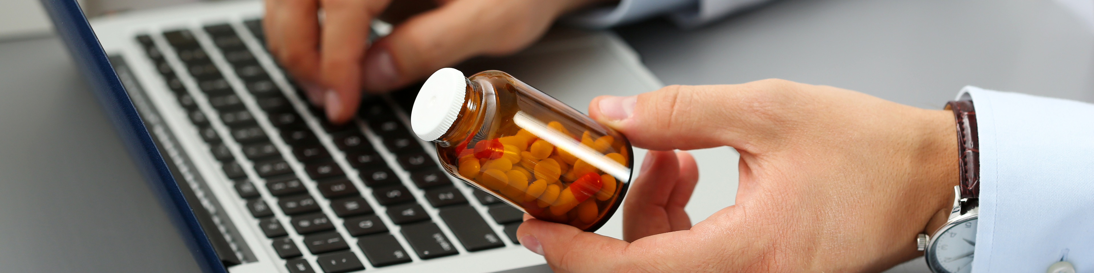 Male medicine doctor hands hold jar of pills