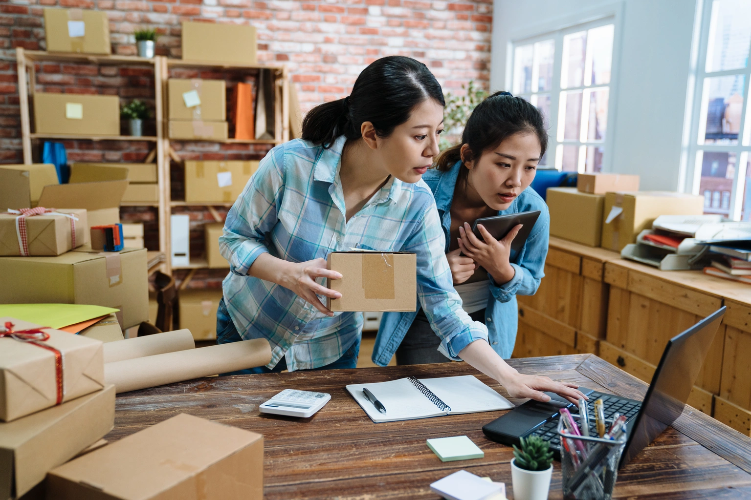 Two woman in a room with boxes