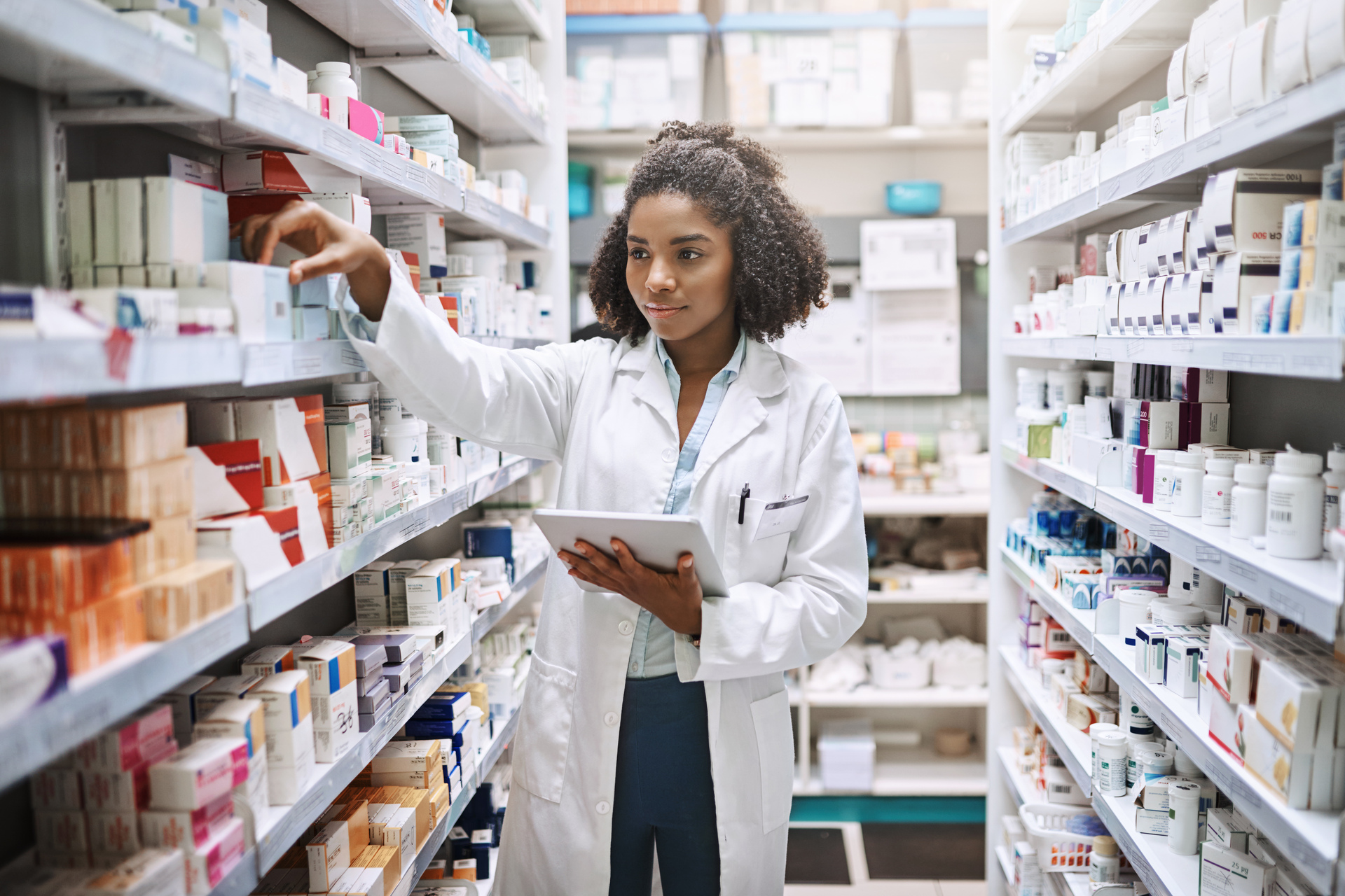 Young African female pharmacist working in a pharmacy.