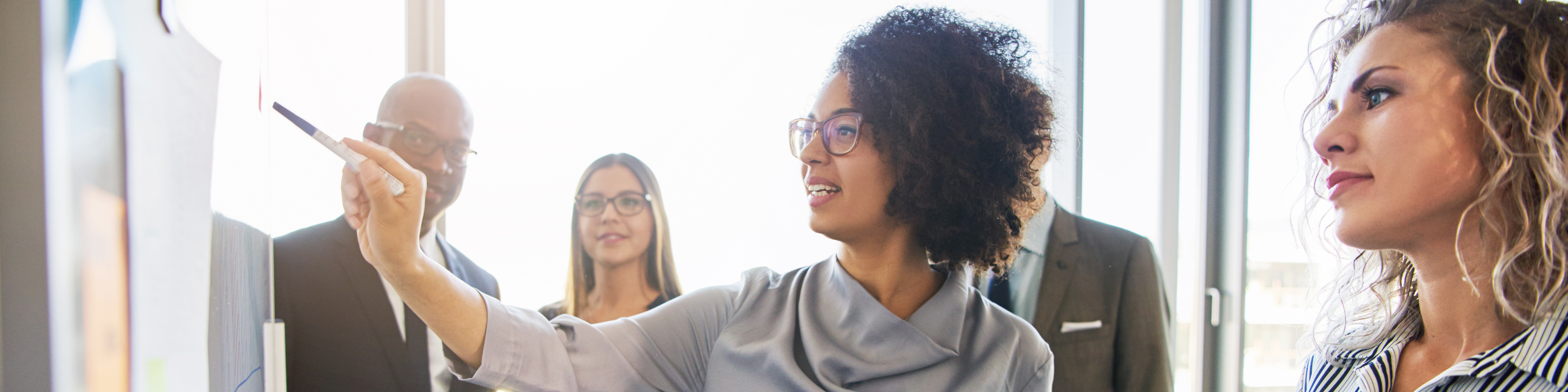 businesspeople standing around having a business meeting