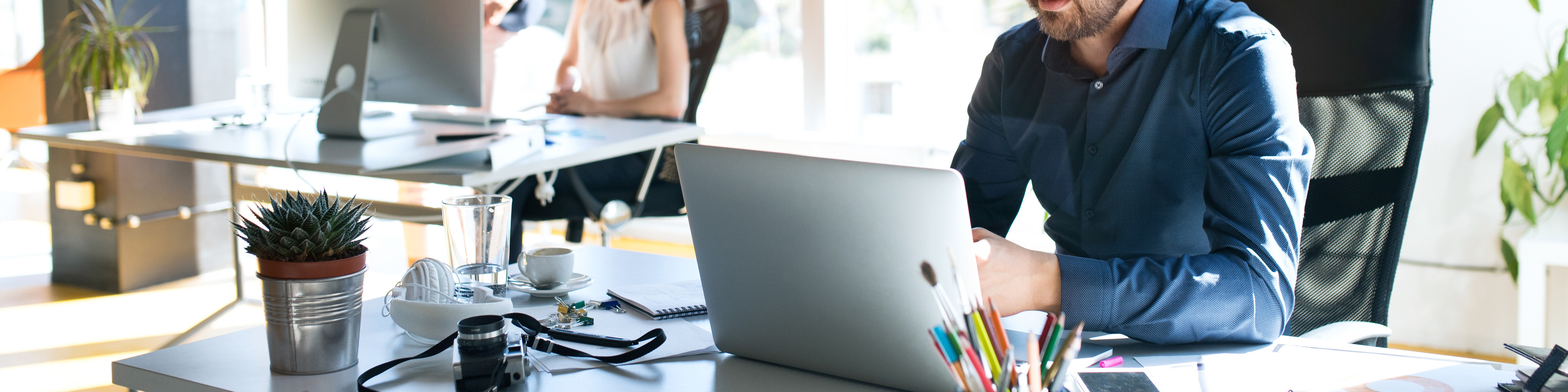 Three business people in the office working together.