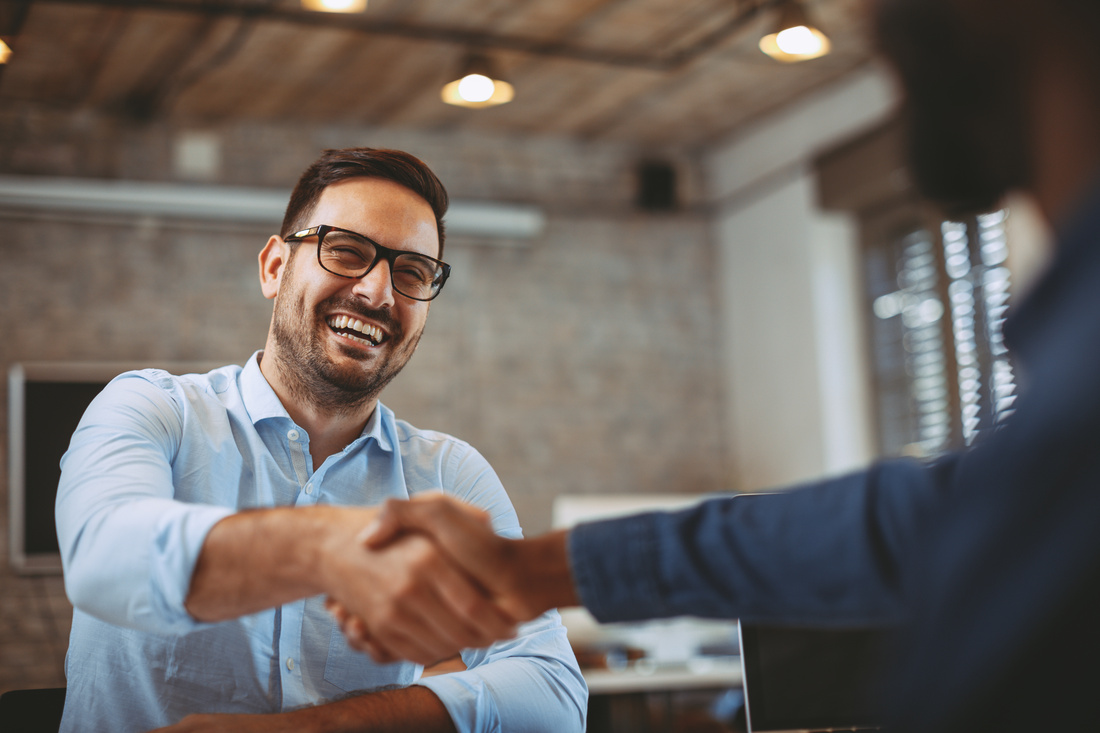 lose up of handshake in the office