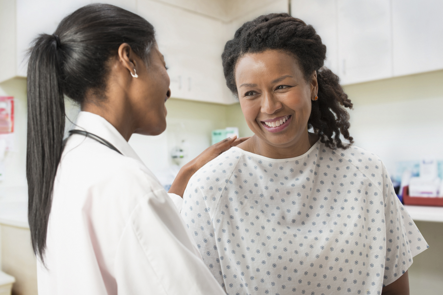 Doctor comforting patient in office