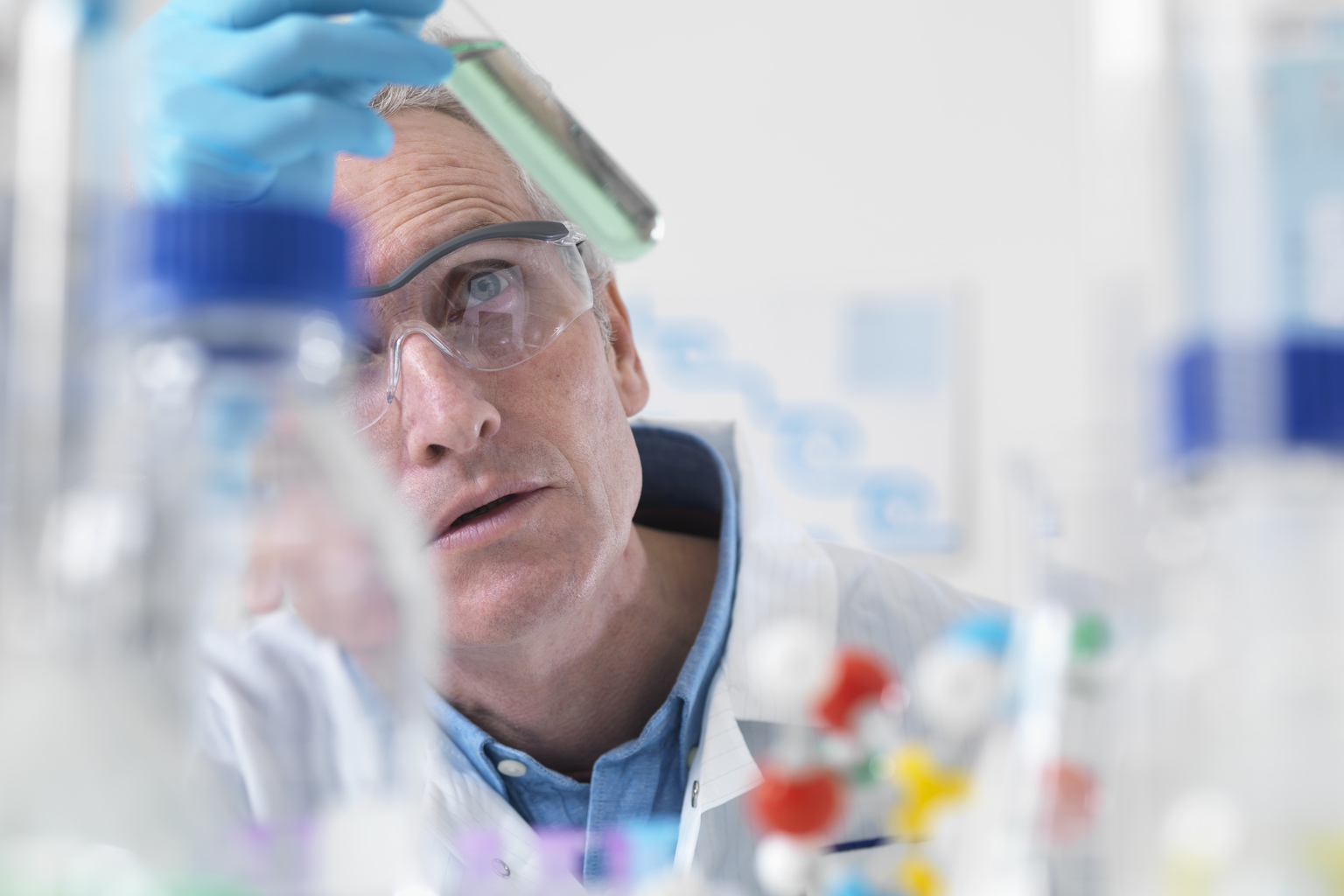 Scientist viewing chemical experiment in laboratory