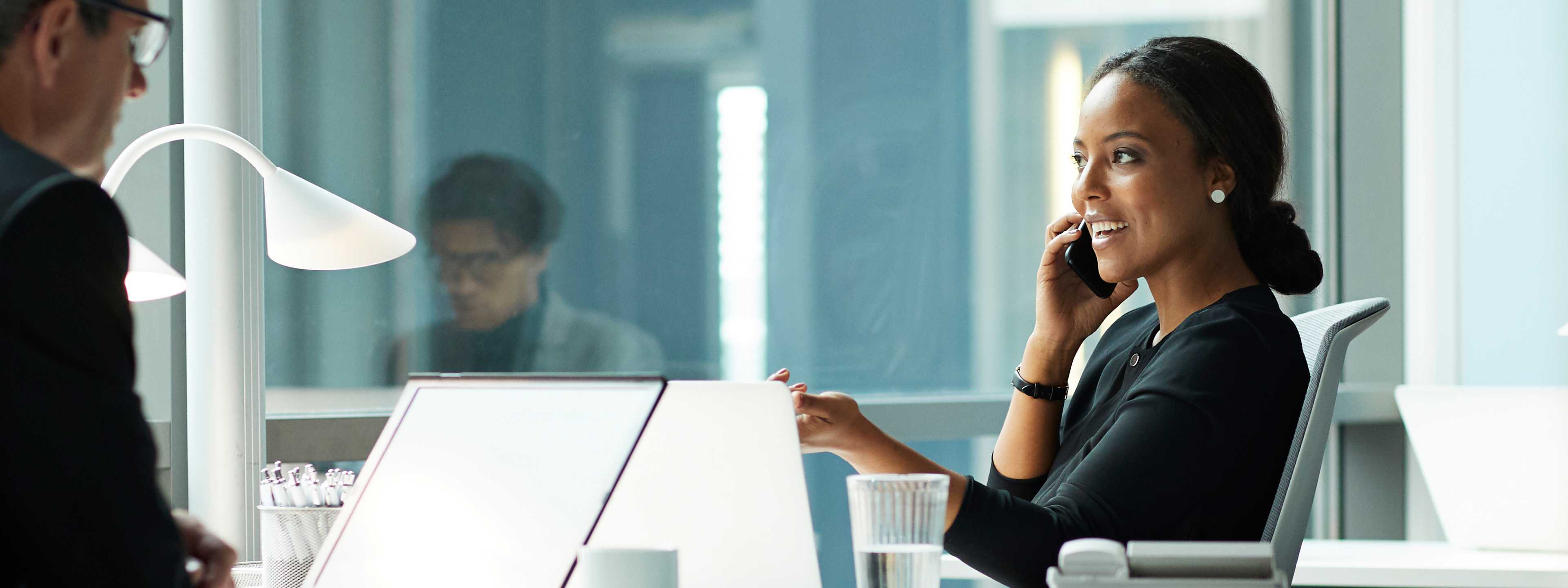 Woman on phone while with colleague