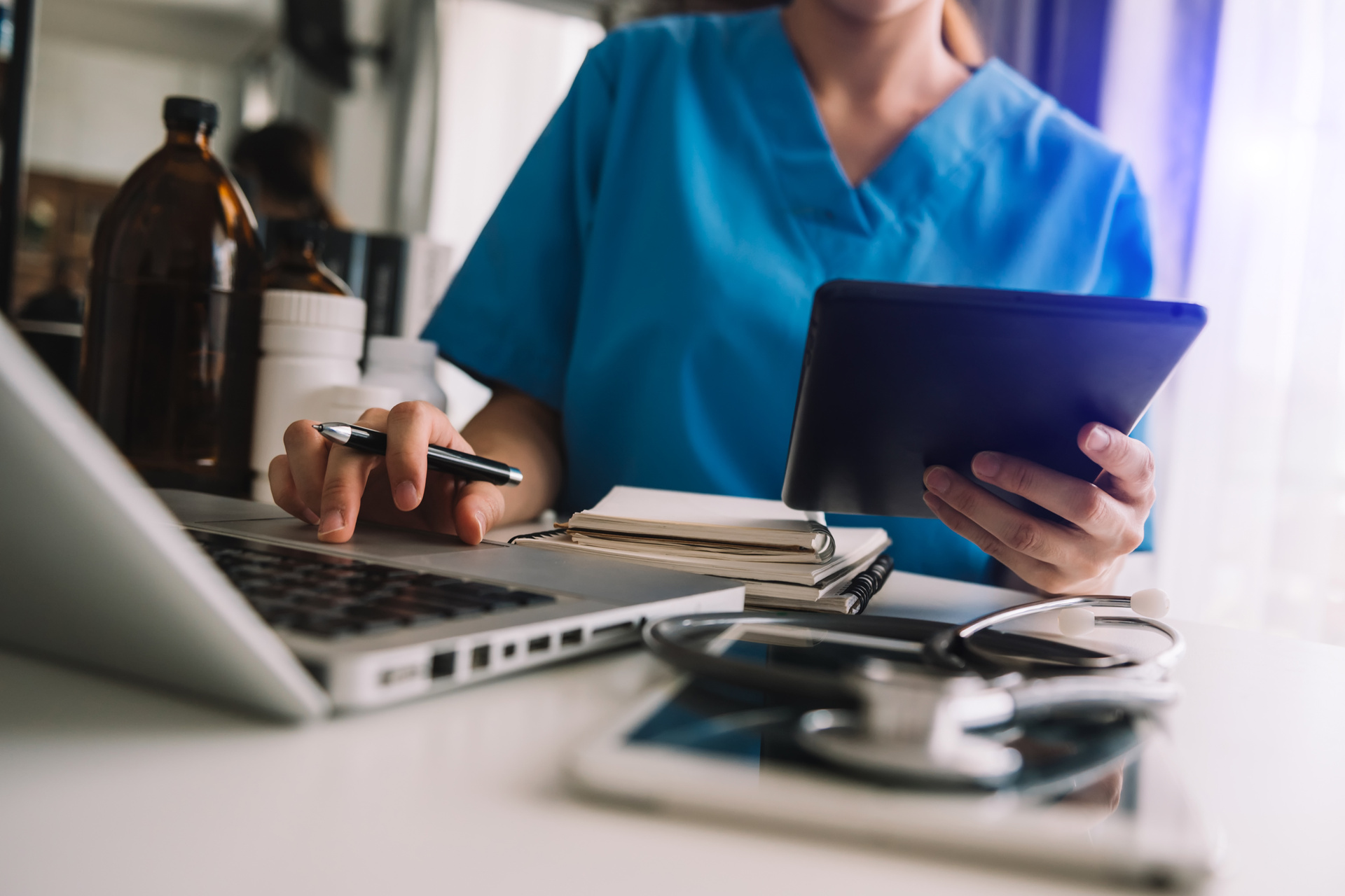 Close up view of person using laptop to research medical information