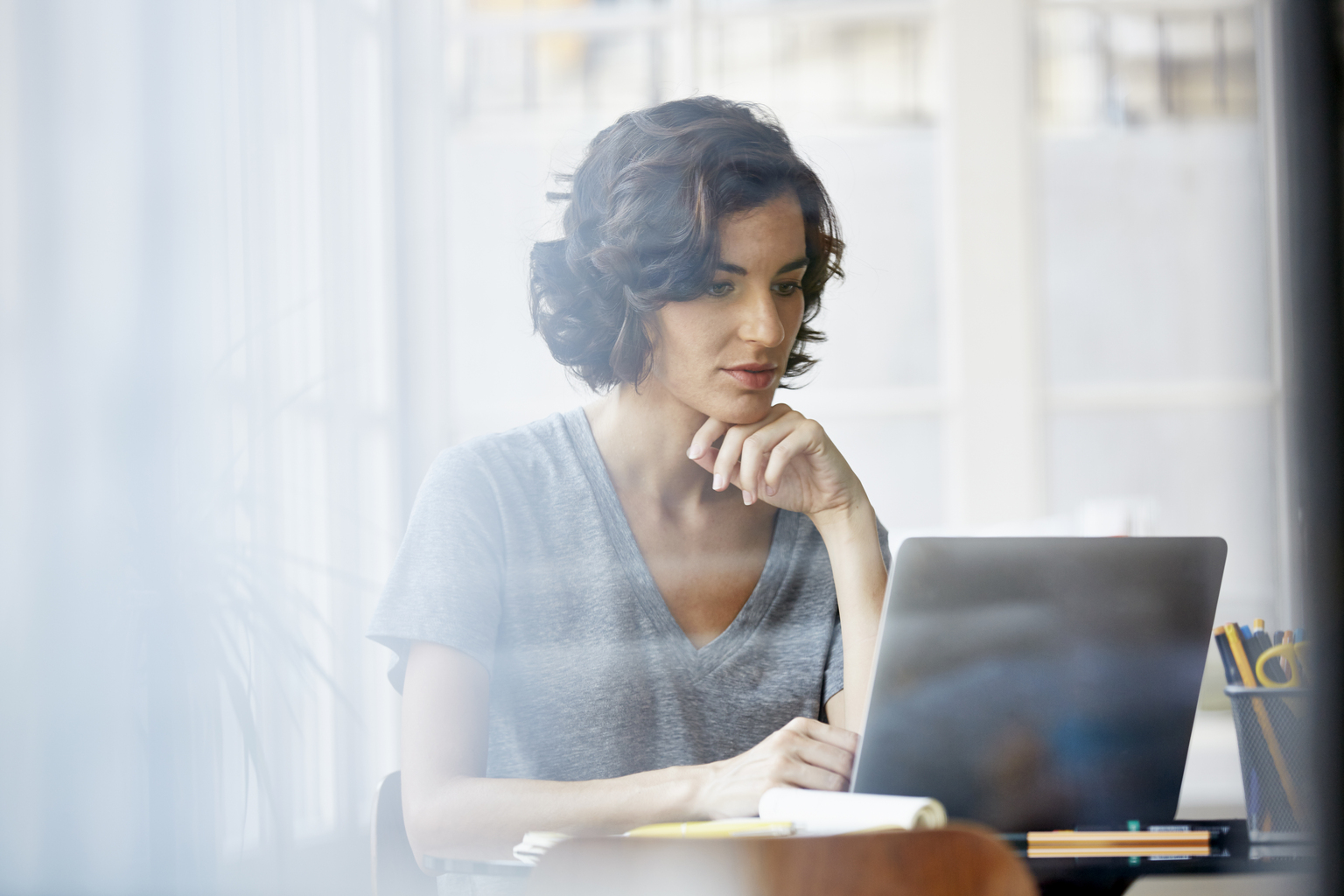 Woman Reading on her laptop