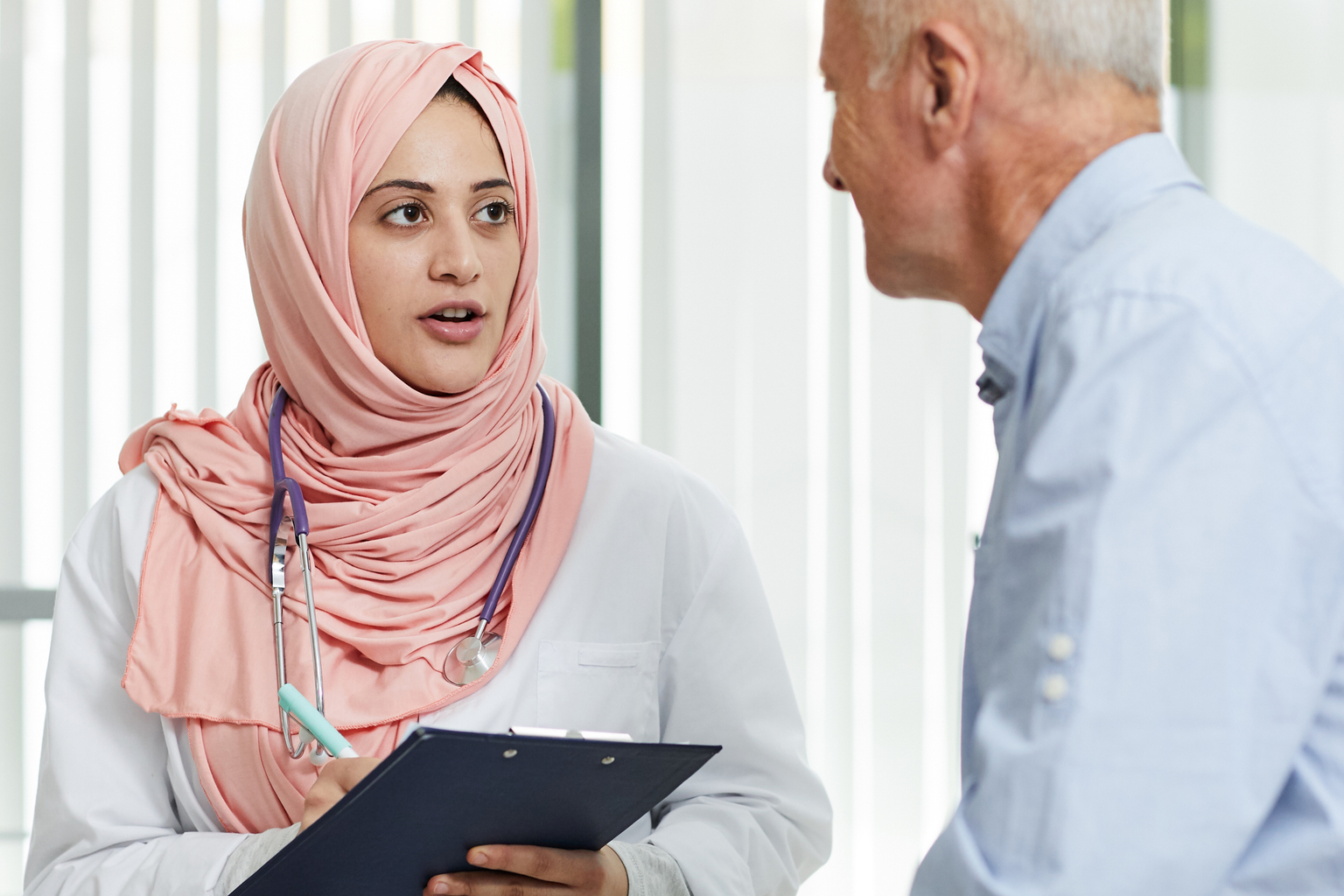 Middle-Eastern doctor talking to patient