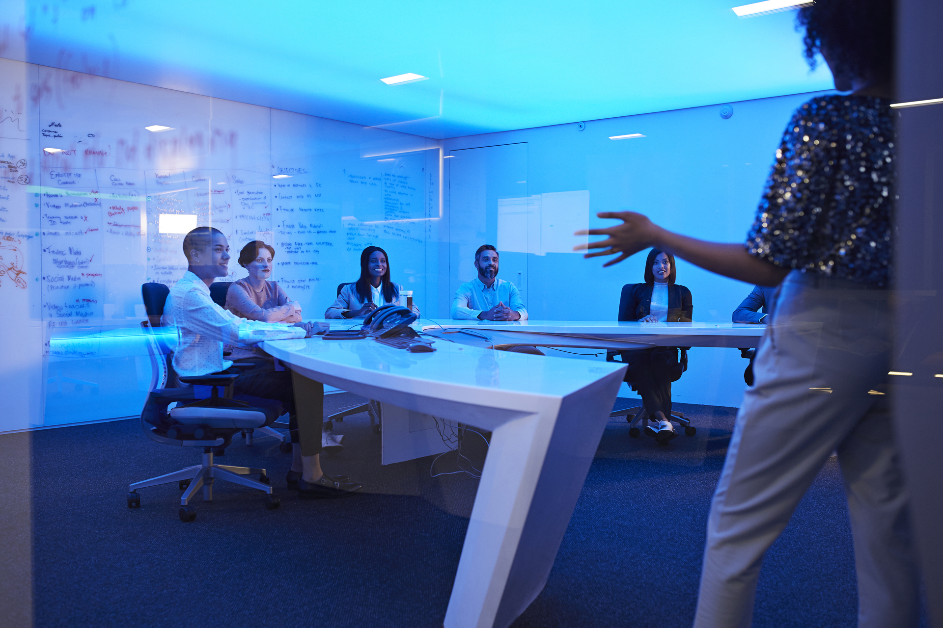 Young businesswoman doing presentation in futuristic board room