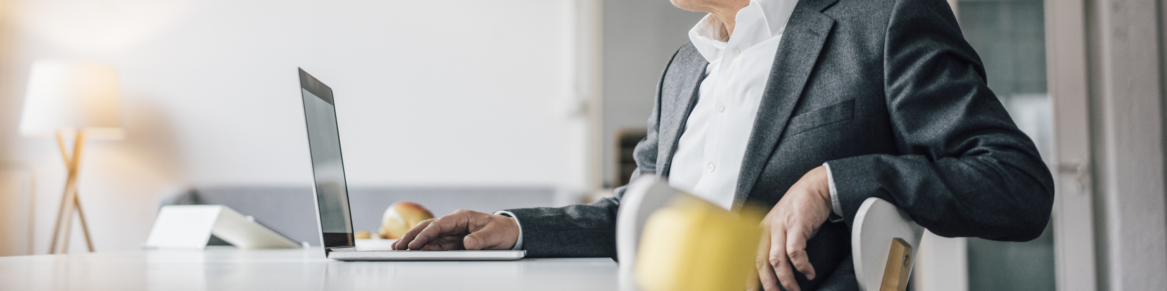 Confident senior businessman using laptop