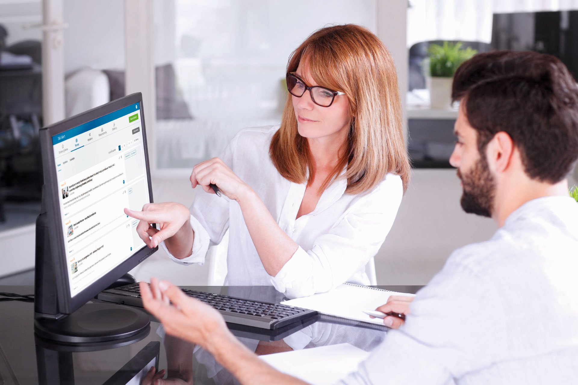 two people looking at a computer screen