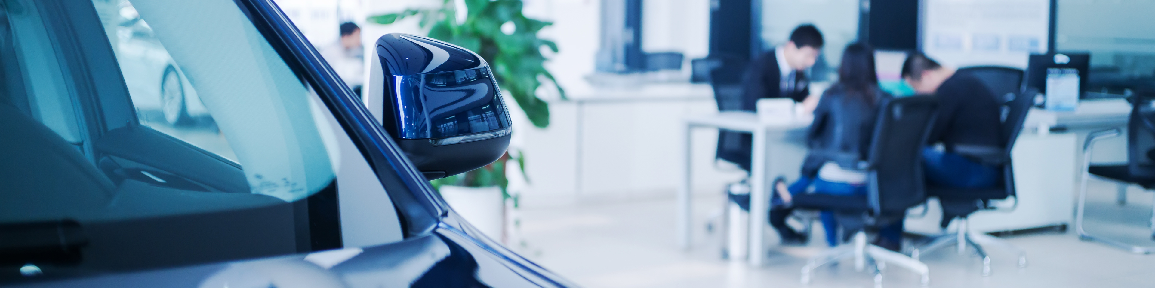 People at a desk in auto dealer