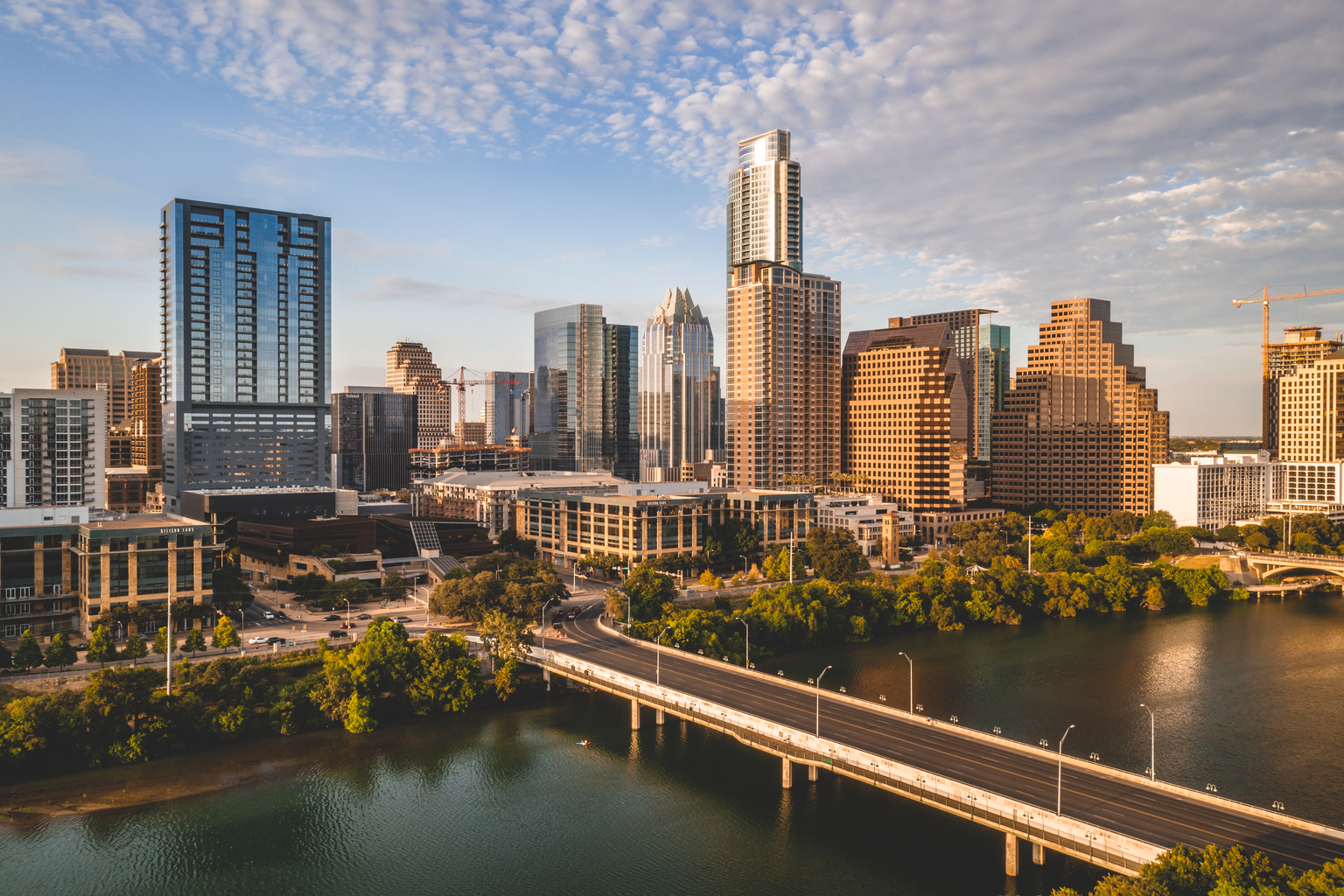 Image of the city, downtown Austin, Texas, Sklyline view, green trees, clouds, and bridge, Q3 2021, TAA NA US - Preparer