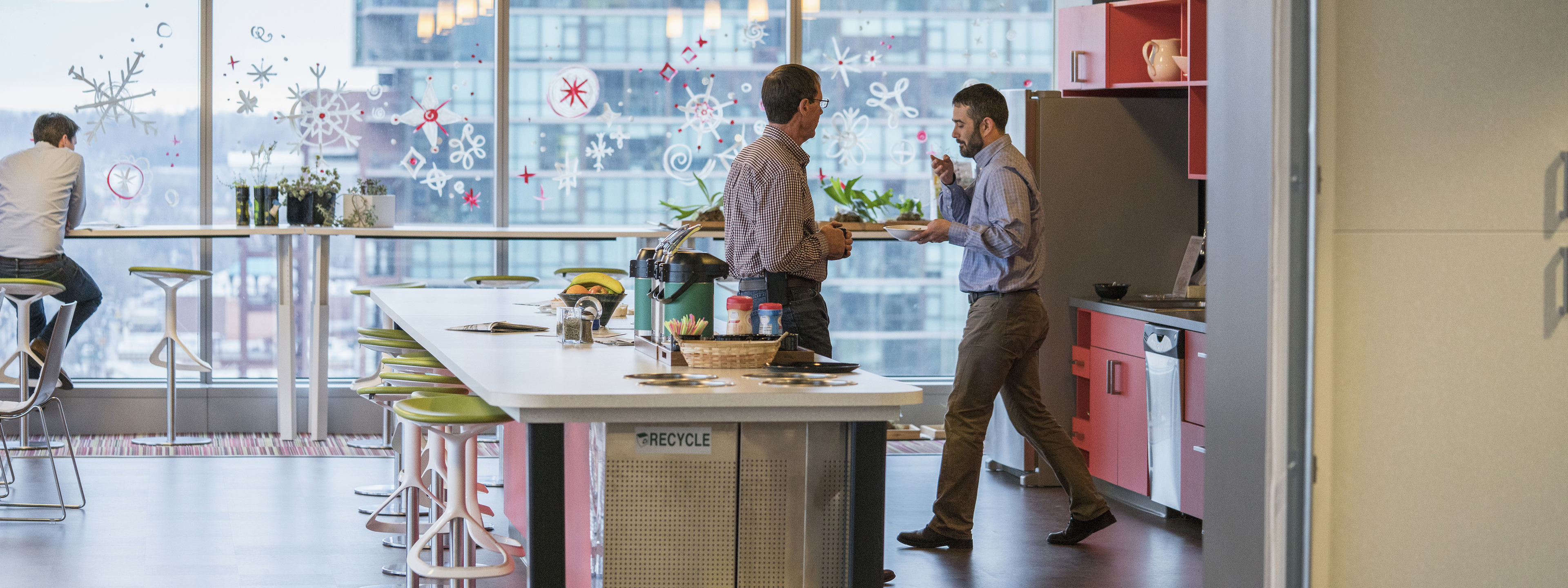 Businessmen talking in office kitchen 