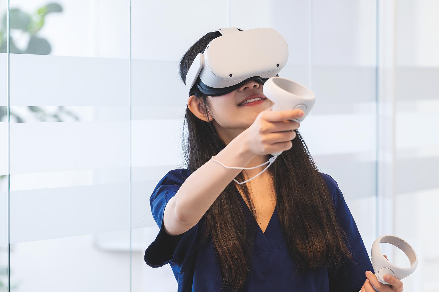 Female nursing student wearing a VR headset while using vrClinicals to enhance her clinical judgement