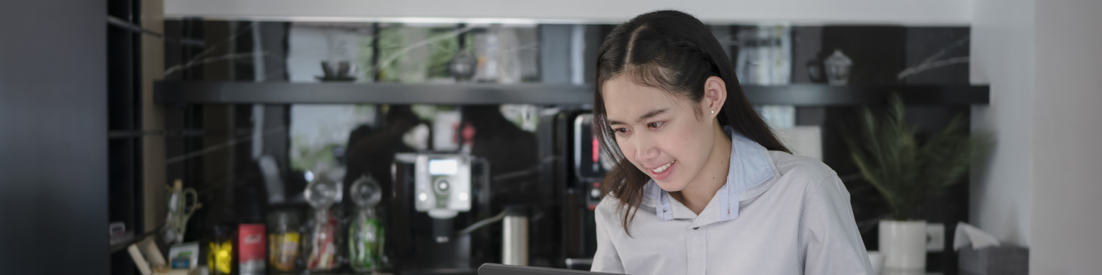 Young Asian woman working at tablet and smart phone.