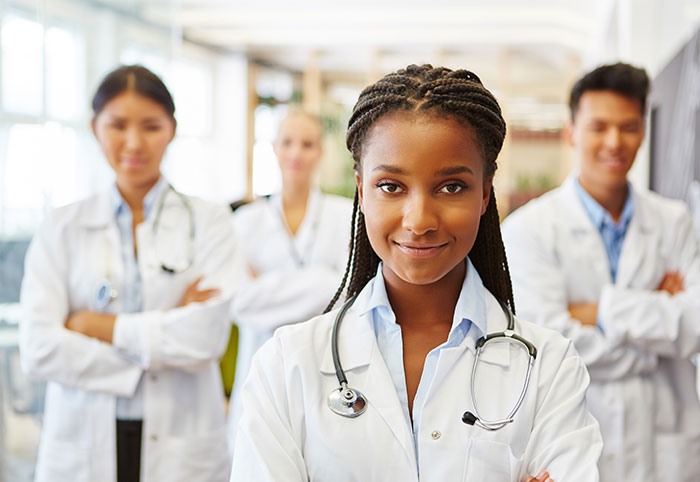 Healthcare workers standing in a group looking at camera