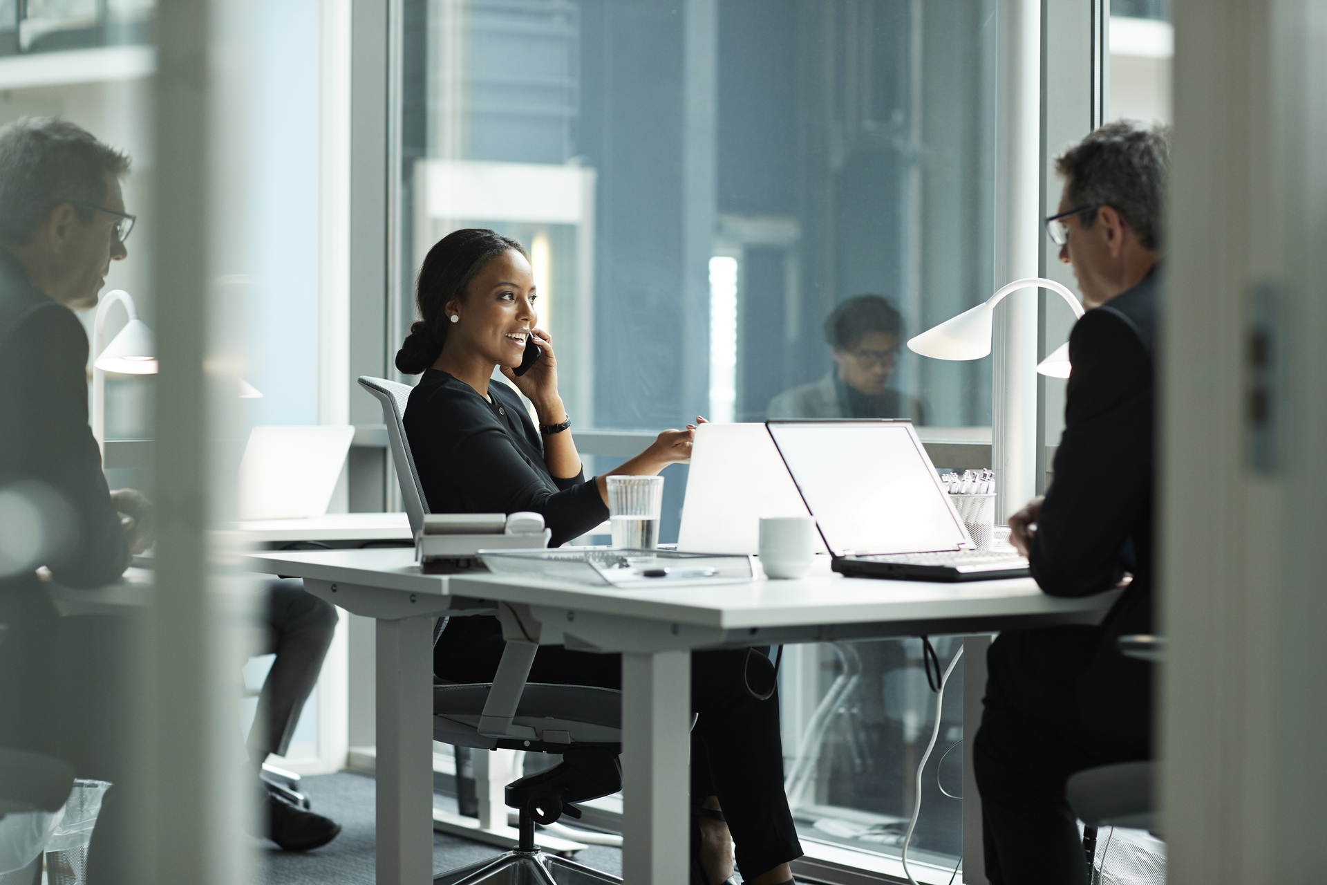 Business woman talking on the phone while working in the office