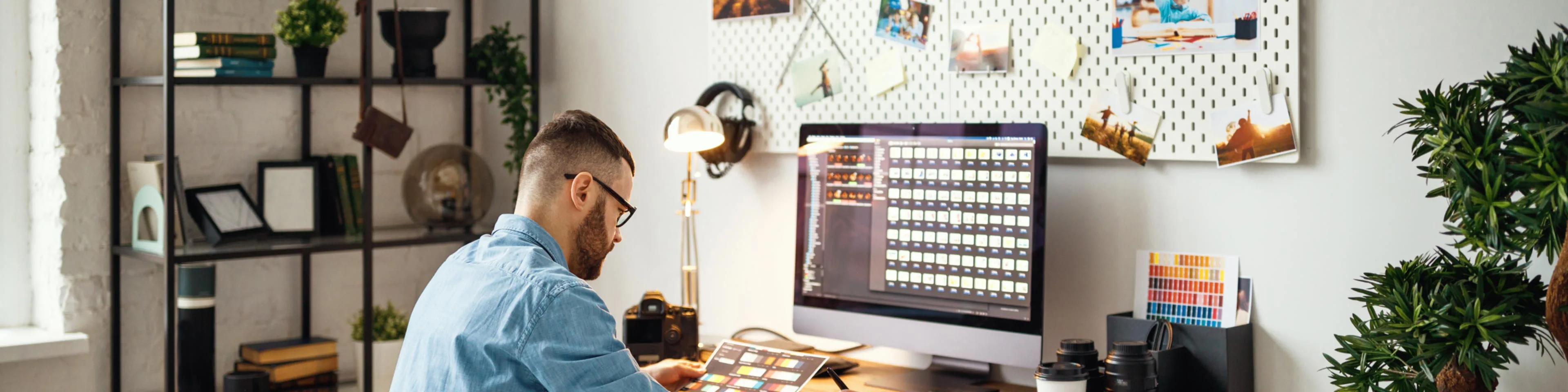 man at desk assessing computer needs for his business