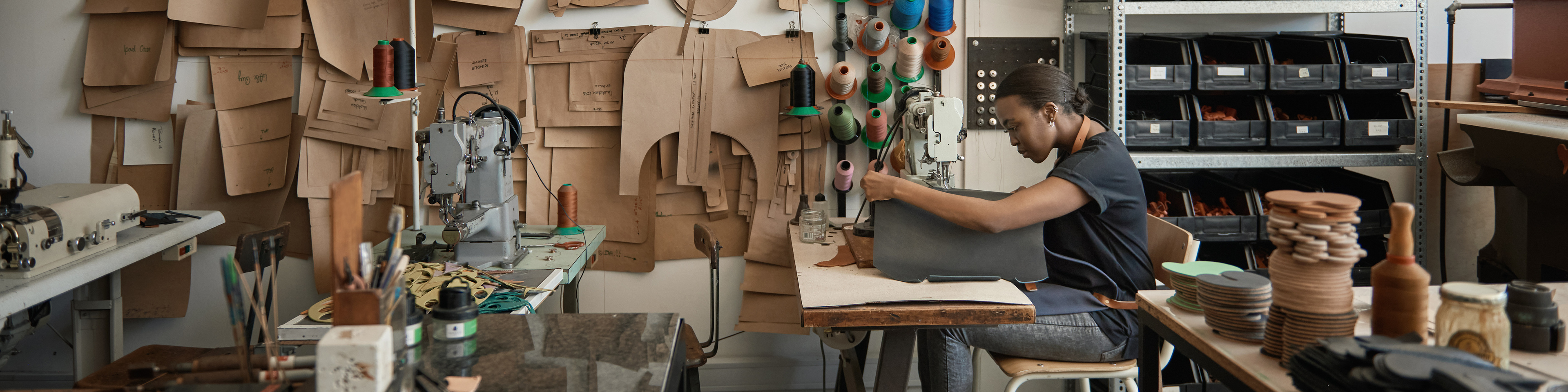 African female artisan using a sewing machine in her artisnal studio