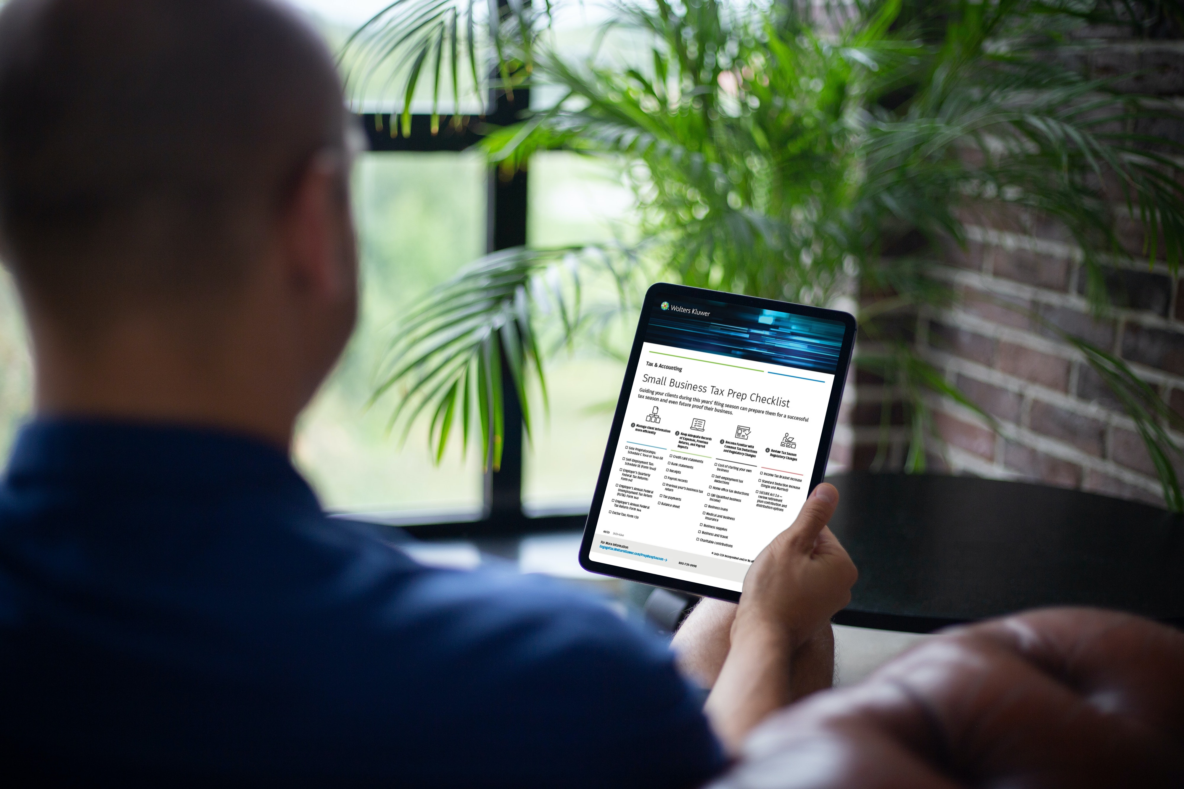 Man viewing Small Business Tax Prep Checklist on an iPad