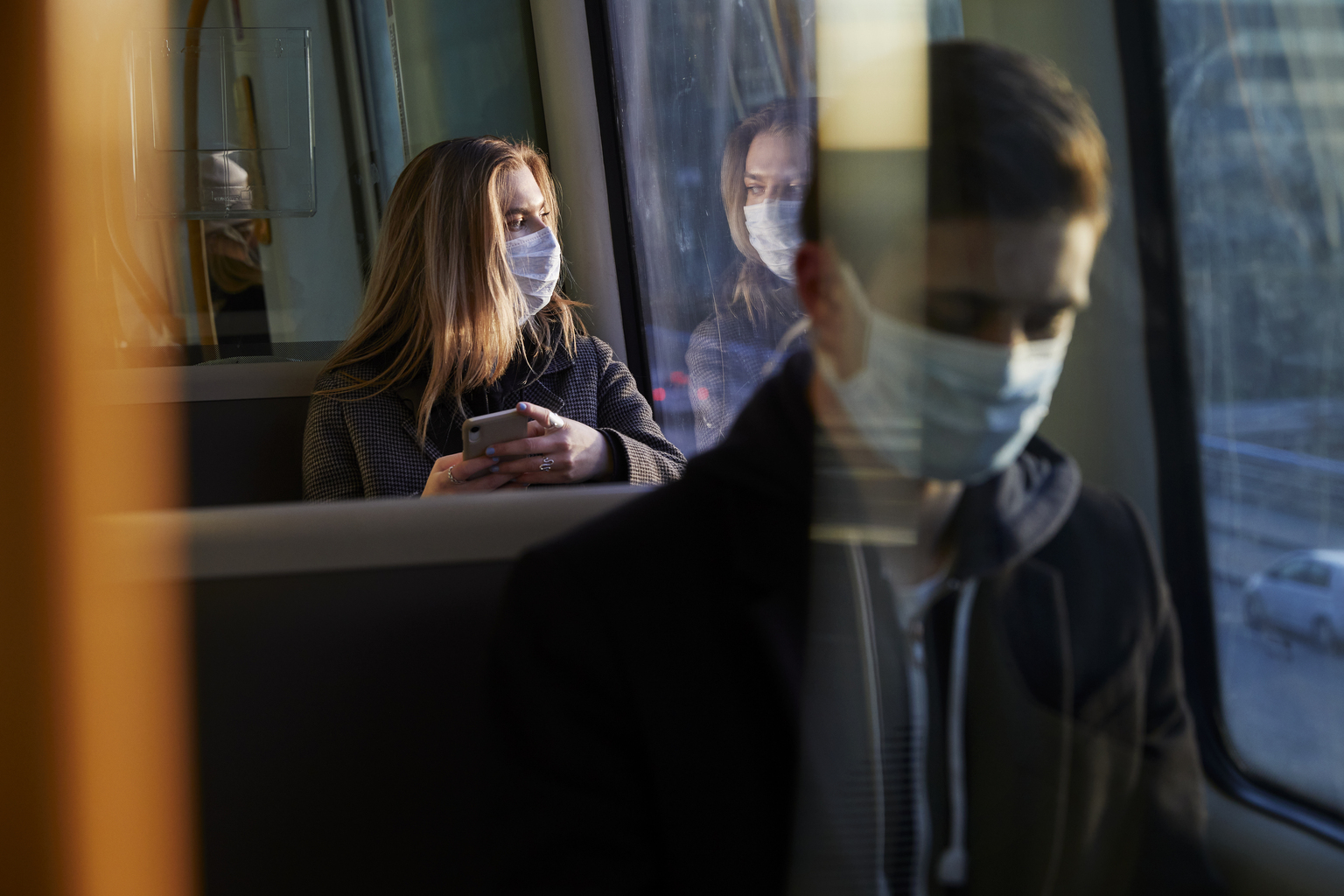 People in public transport wearing mask while commuting
